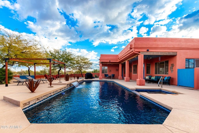 view of swimming pool featuring pool water feature and a patio