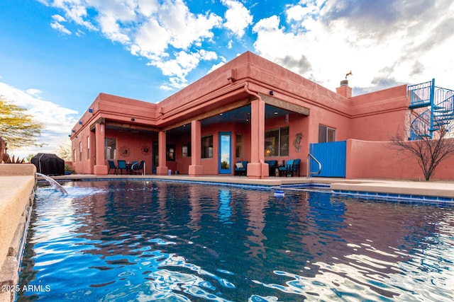 view of swimming pool featuring area for grilling and a patio