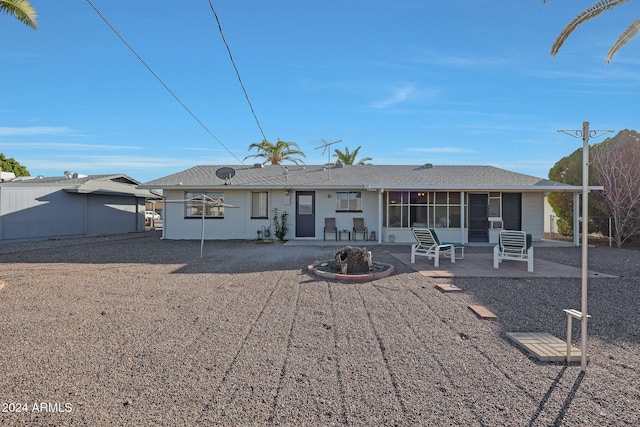 back of house featuring a sunroom and a patio