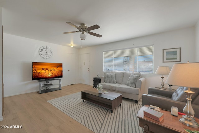 living room with ceiling fan and light hardwood / wood-style flooring