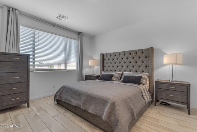 bedroom with baseboards and light wood-style flooring
