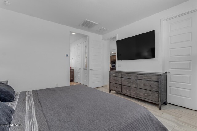 bedroom with light wood finished floors