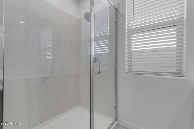 full bathroom featuring a marble finish shower