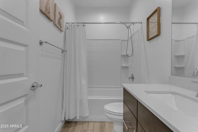 bathroom featuring shower / bath combination with curtain, toilet, and vanity