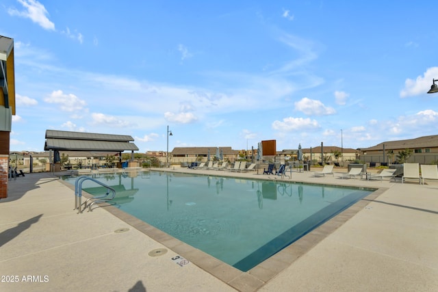 community pool featuring a patio area and fence