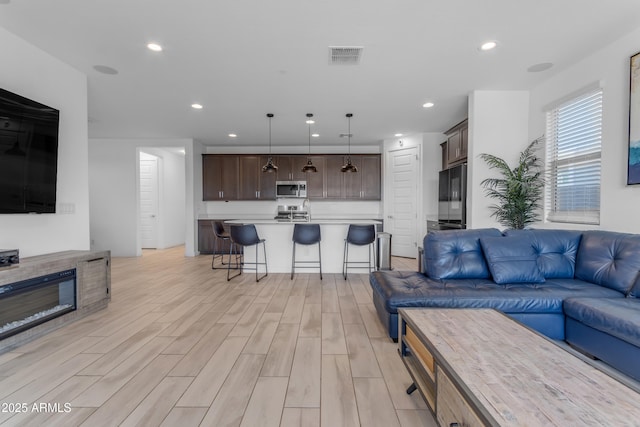 living room featuring light wood-style floors and recessed lighting