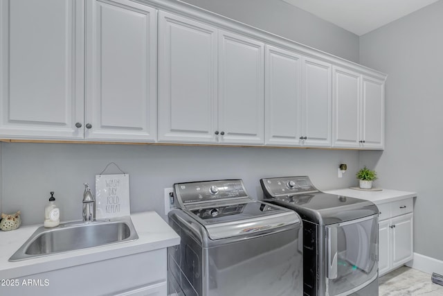 washroom with sink, cabinets, and independent washer and dryer