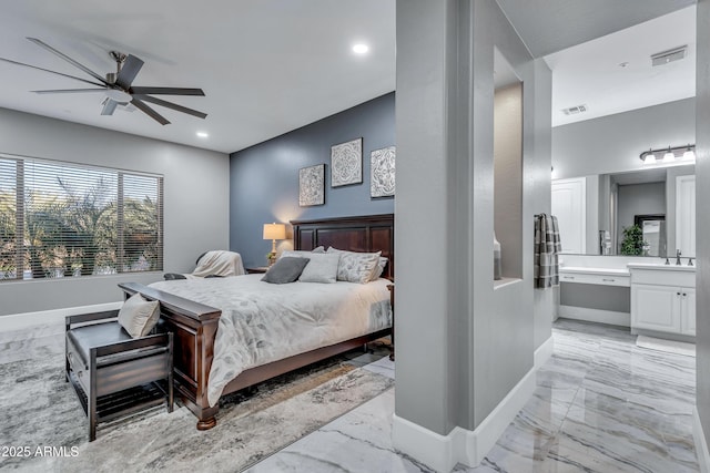 bedroom featuring ceiling fan, sink, and ensuite bathroom