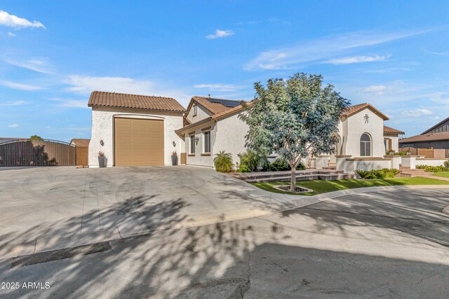 mediterranean / spanish-style house with a garage