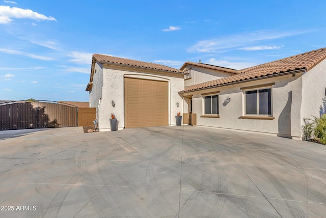 mediterranean / spanish-style home with a garage