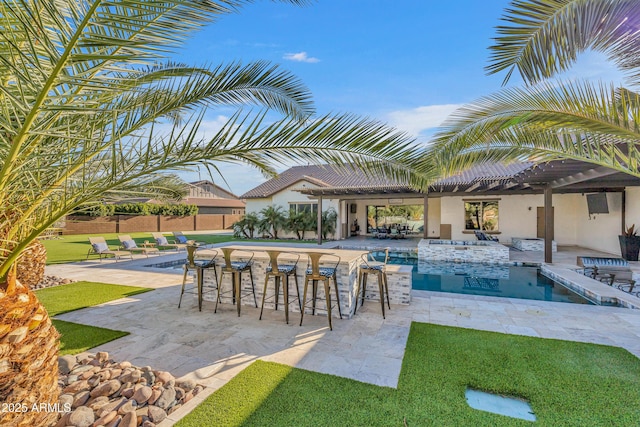 view of swimming pool featuring an outdoor bar and a patio