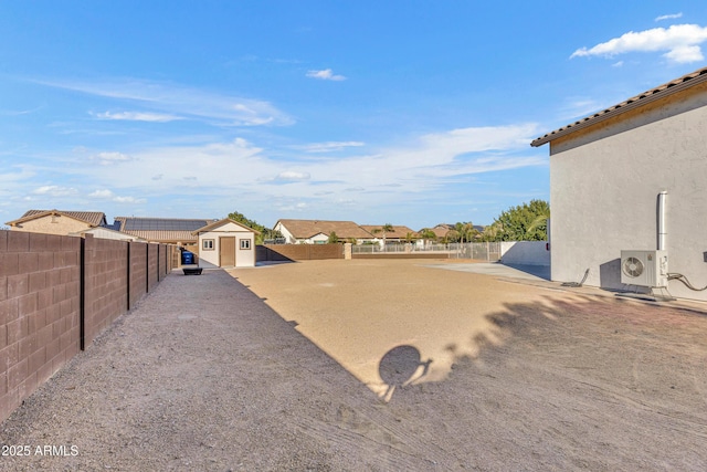 view of yard featuring ac unit and a storage unit