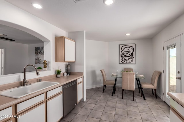kitchen with a sink, recessed lighting, light countertops, and dishwasher