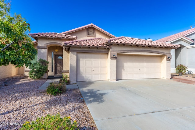 mediterranean / spanish-style home featuring a garage