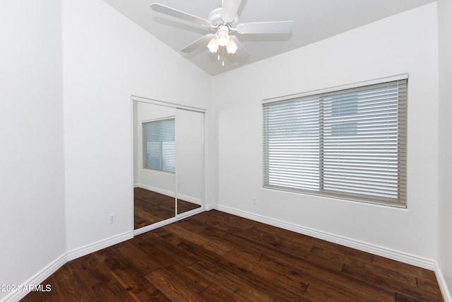 unfurnished bedroom with a closet, ceiling fan, lofted ceiling, and dark hardwood / wood-style floors