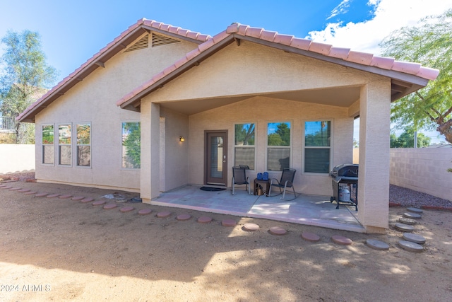 rear view of property featuring a patio area