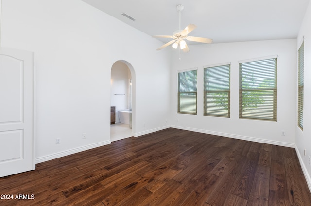 unfurnished room with ceiling fan, dark hardwood / wood-style floors, and vaulted ceiling