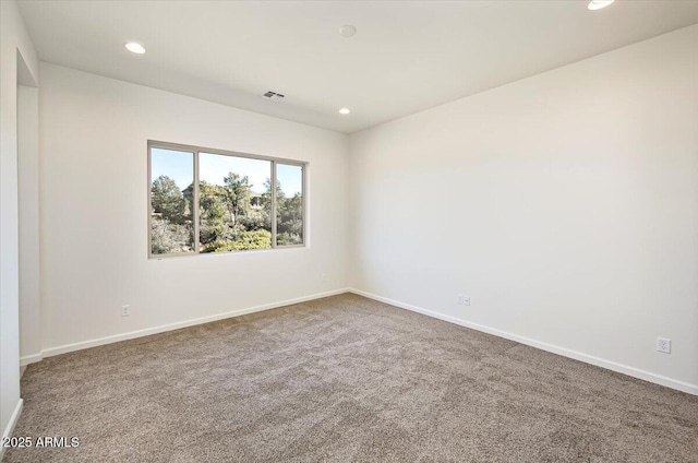 empty room featuring baseboards and carpet