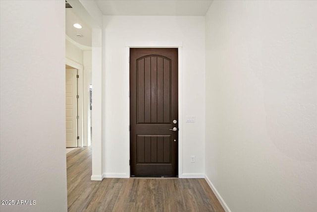 doorway featuring baseboards, recessed lighting, and wood finished floors