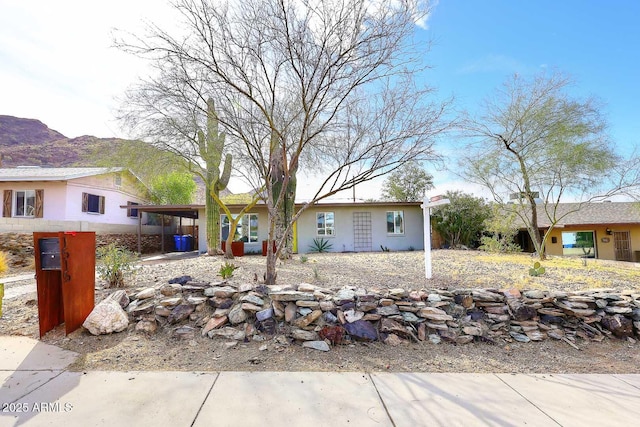 ranch-style home with a mountain view and a carport