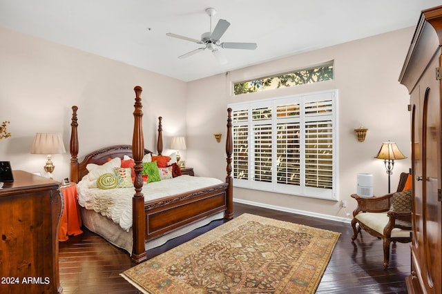 bedroom with dark wood-type flooring, baseboards, and a ceiling fan