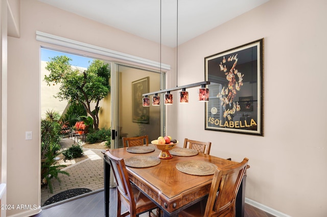 dining room with dark wood finished floors and baseboards