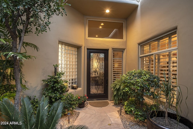 entrance to property with stucco siding