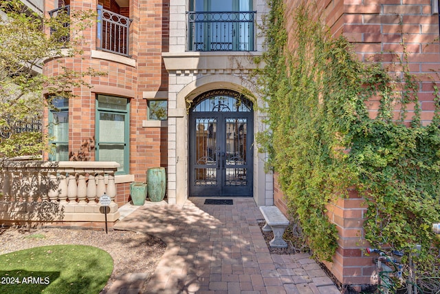 property entrance with a balcony and french doors