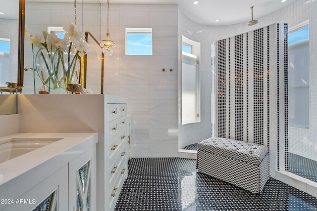 bathroom with a chandelier and tiled shower