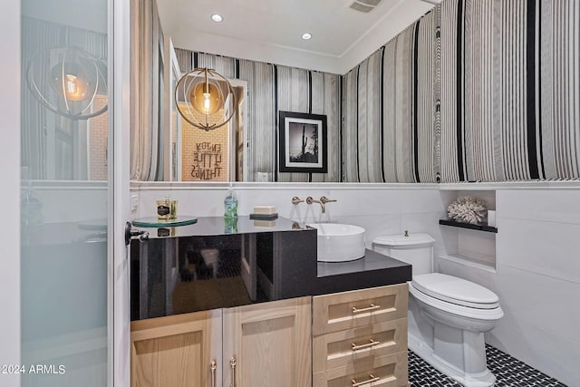 bathroom with vanity, tile patterned flooring, and toilet