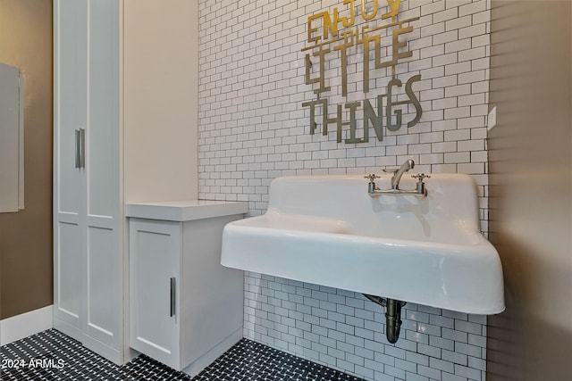 bathroom with tile walls and tile patterned flooring