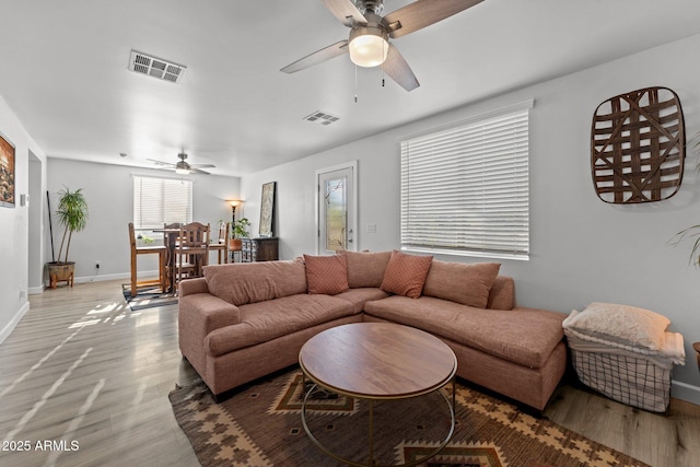 21647 W Laura St, Wittmann, AZ 85361 - living area with ceiling fan and wood finished floors