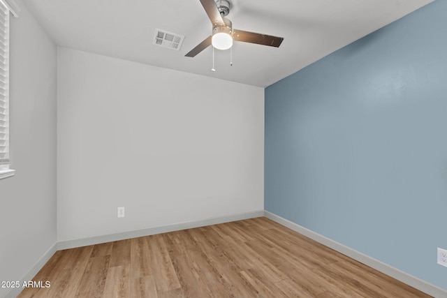 21647 W Laura St, Wittmann, AZ 85361 - spare room featuring wood finished floors and ceiling fan