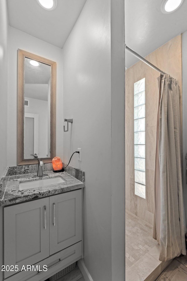 21647 W Laura St, Wittmann, AZ 85361 - full bath featuring tiled shower, vanity, and marble look tile flooring