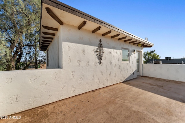 21647 W Laura St, Wittmann, AZ 85361 - view of side of home featuring stucco siding and a patio area