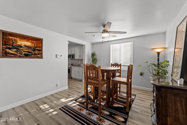 21647 W Laura St, Wittmann, AZ 85361 - dining space with a ceiling fan and light wood-style floors
