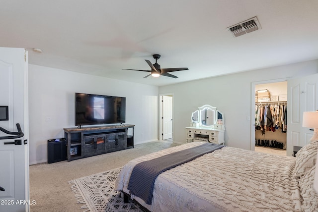 1145 E Lowell Ave, Gilbert, AZ 85295 - carpeted bedroom with baseboards, a walk in closet, and a ceiling fan