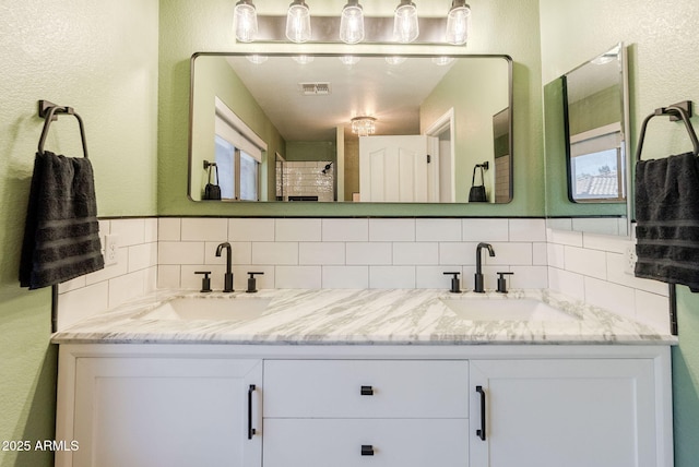 1145 E Lowell Ave, Gilbert, AZ 85295 - full bath featuring tasteful backsplash, double vanity, a textured wall, and a shower