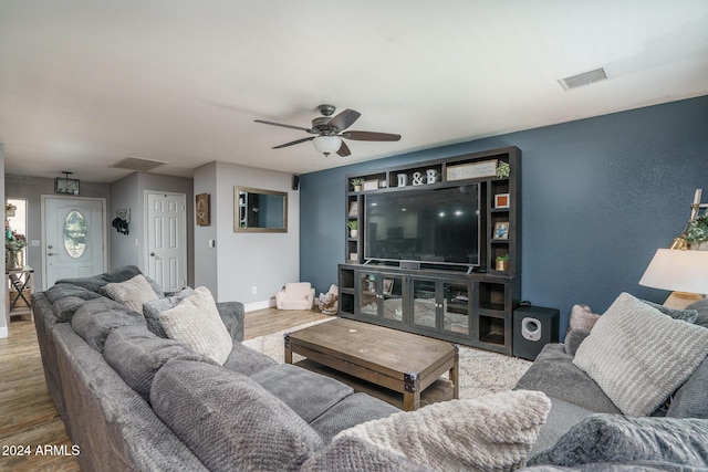 living room featuring hardwood / wood-style flooring and ceiling fan