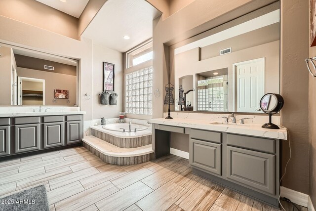 12448 N 129th Pl, Scottsdale, AZ 85259 - bathroom featuring a garden tub, two vanities, wood finish floors, and a shower