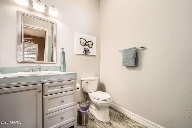 12448 N 129th Pl, Scottsdale, AZ 85259 - half bath with toilet, vanity, wood finished floors, and baseboards