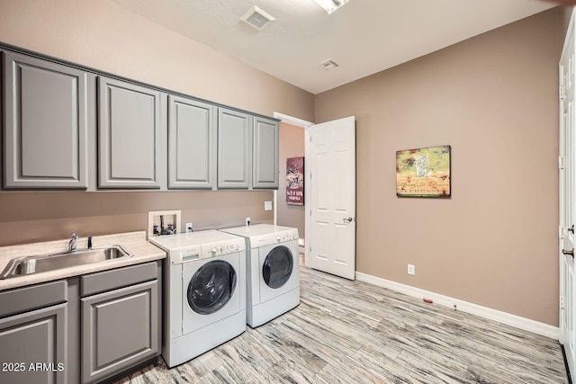 12448 N 129th Pl, Scottsdale, AZ 85259 - laundry room with cabinet space, washing machine and clothes dryer, light wood finished floors, and baseboards