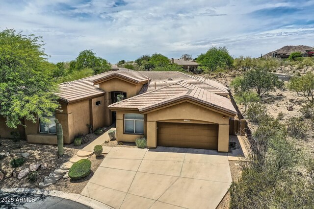 12448 N 129th Pl, Scottsdale, AZ 85259 - view of front of home featuring driveway, a tiled roof, stucco siding, and an attached garage