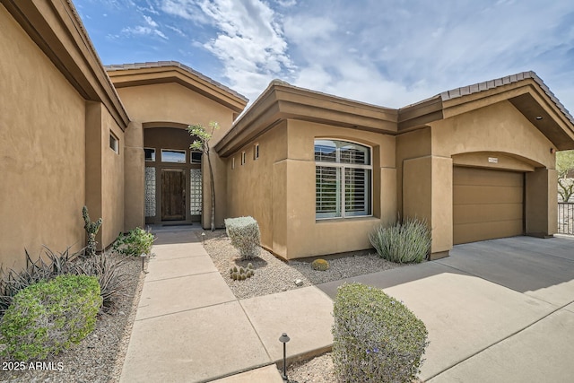12448 N 129th Pl, Scottsdale, AZ 85259 - entrance to property with stucco siding, an attached garage, and concrete driveway