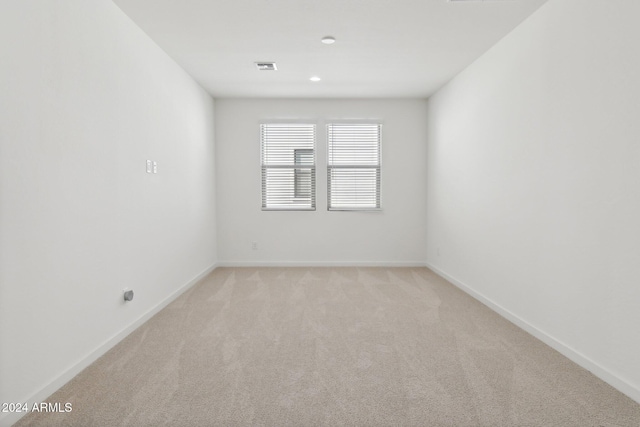 empty room with light colored carpet