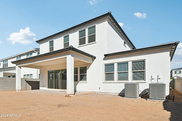 back of property with cooling unit and a patio