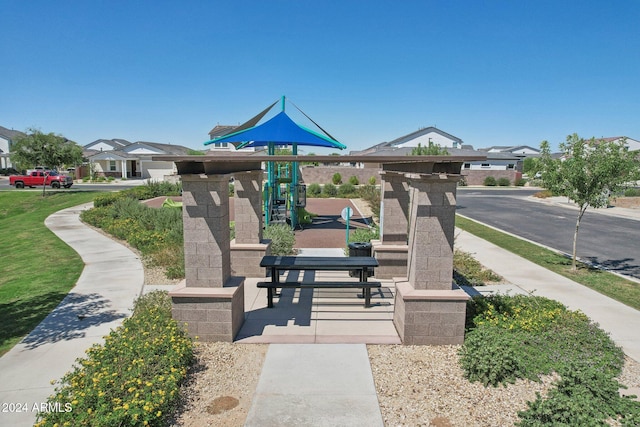 surrounding community featuring a playground and a yard