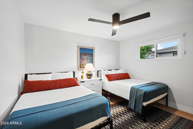 bedroom with ceiling fan and dark wood-type flooring