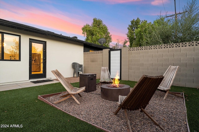 patio terrace at dusk with a fire pit