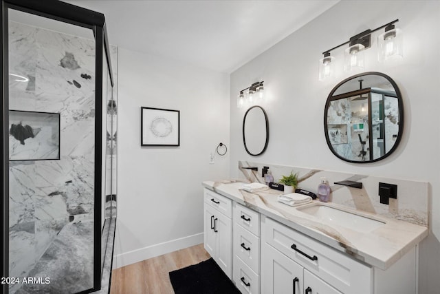 bathroom featuring a shower, hardwood / wood-style floors, and vanity